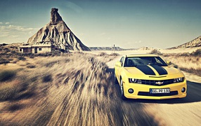 Yellow Chevrolet Camaro racing in the desert