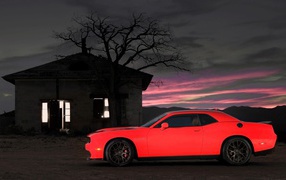 Car Dodge Challenger SRT on the background of the house