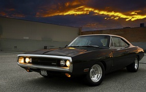 Dodge Charger on a background of orange clouds