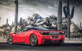 Красный Ferrari у горы из камней