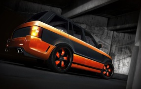 Orange Land Rover with a black stripe