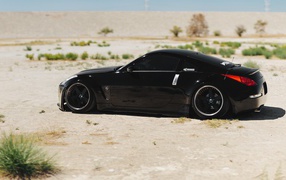 Black Nissan 350Z on the white sand