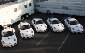 Five identical white Porsche