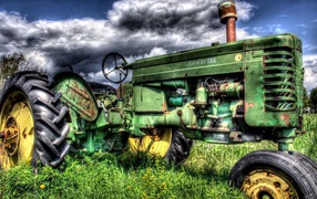 Green tractor in the field
