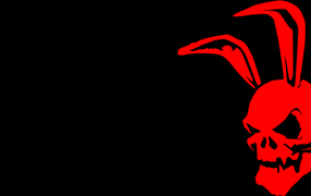 Красный череп с заячьими ушами на черном фоне