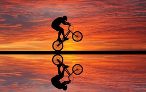 Biking on sunset background