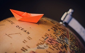 Бумажный кораблик на глобусе