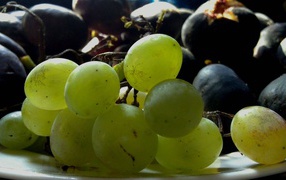 Large white and black grapes on a plate
