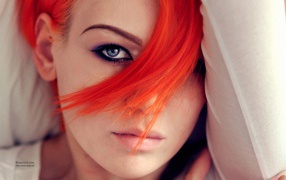 Прядь оранжевых волос на лице у девушки