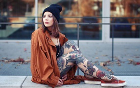 Girl in a hat with a tattoo on his feet