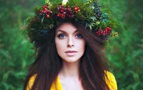 Девушка с венком из травы и ягод на голове