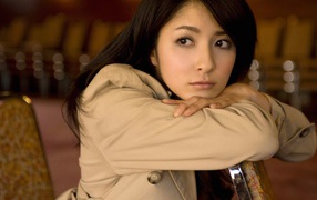 Sad Asian girl in a brown cloak