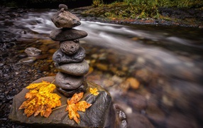 Pile of stones on a boulder near the stream