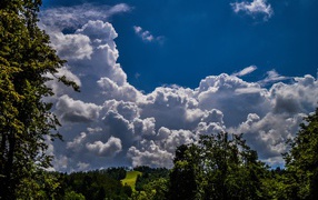 Cumulus clouds over the green hills