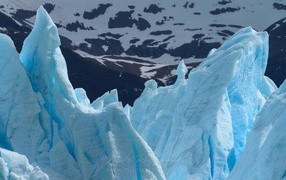 Глыбы голубого льда на фоне гор