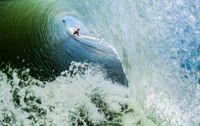 Surfer in foamy waves