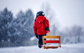 Ребенок везет санки