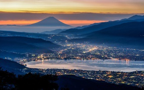 Night city on a background of Mount Fuji, Japan