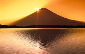The sun is hiding behind the mountain Fuji