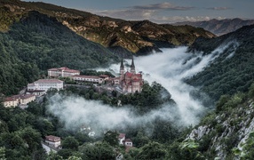 Castle in the mountains among the clouds