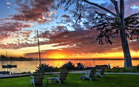 Deck chairs on the shore of the lake at sunset, HDR Photos