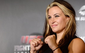 Блондинка Миша Тейт держит кулаки