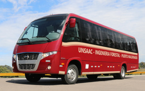 Красный автобус Volare W9 Executivo на дороге