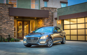 Серебристый автомобиль Genesis G80 с включенными фарами