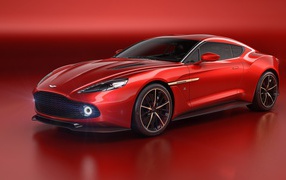 Стильный красный автомобиль Aston Martin Vanquish Zagato на красном фоне 