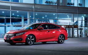 Стильный красный автомобиль Honda Civic в автосалоне