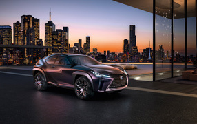 A stylish crossover Lexus UX in the background of a night city