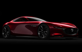 Красный спортивный автомобиль Mazda RX Vision Concept на черном фоне