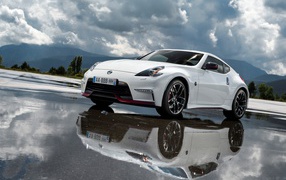 White car Nissan 370z Nismo, 2018 on a cloudy sky background