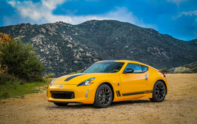Yellow car Nissan 370Z Heritage Edition, 2018 amid the mountains