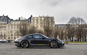 Black sports car Porsche 911 in the city