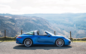 Blue Car Convertible Porsche 911 Targa 4S on the background of the mountains