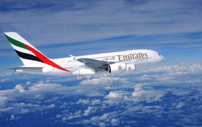 Airliner Airbus A380 Emirates airline flight above the clouds