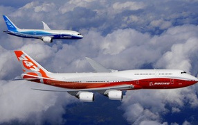 Two passenger aircraft Boeing 747 in sky blue and white-red-white