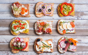 Аппетитные бутерброды на деревянном столе вид сверху