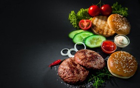 Fresh products for a hamburger on a gray background