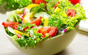 Fresh vegetable salad with greens on the table