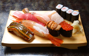 Japanese sushi on a wooden board with seafood