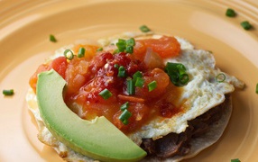 Омлет с соусом, кусочком авокадо на завтрак