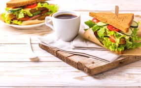 Sandwich on the table with a cup of coffee for breakfast