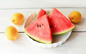 Кусочки сладкого арбуза с абрикосами на столе