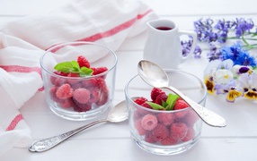 Raspberries in transparent glasses for breakfast on the table