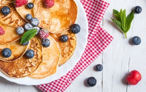 Appetizing fresh pancakes with blueberries and strawberries