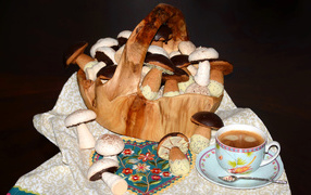 Cookies mushrooms in a basket with coffee on the table