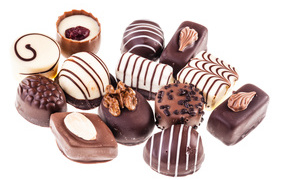 Appetizing assorted chocolates on white background