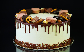 Appetizing cake is decorated with chocolate, Oreo cookies and macaroons